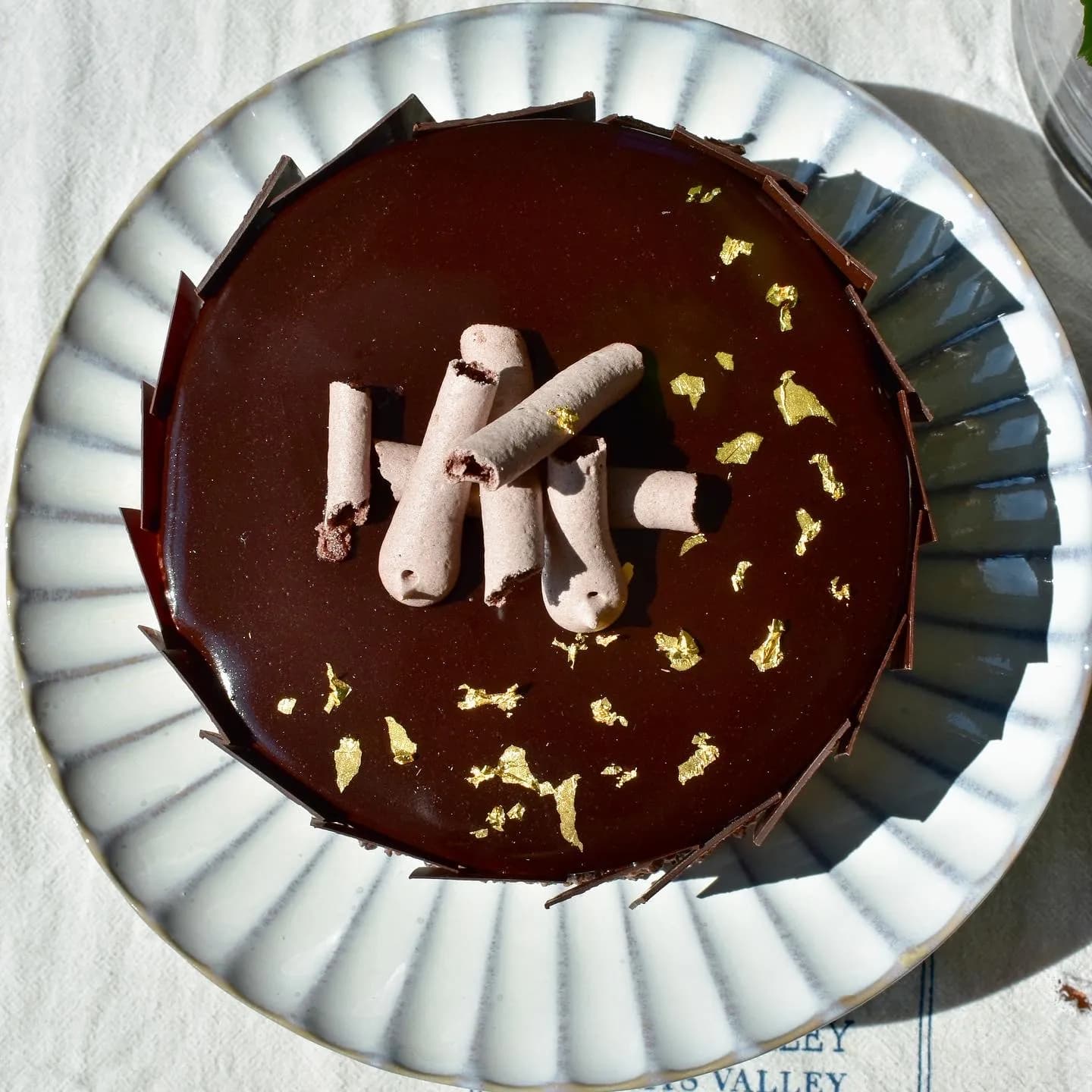 chocolate mousse cake with tempered panels and gold leaf