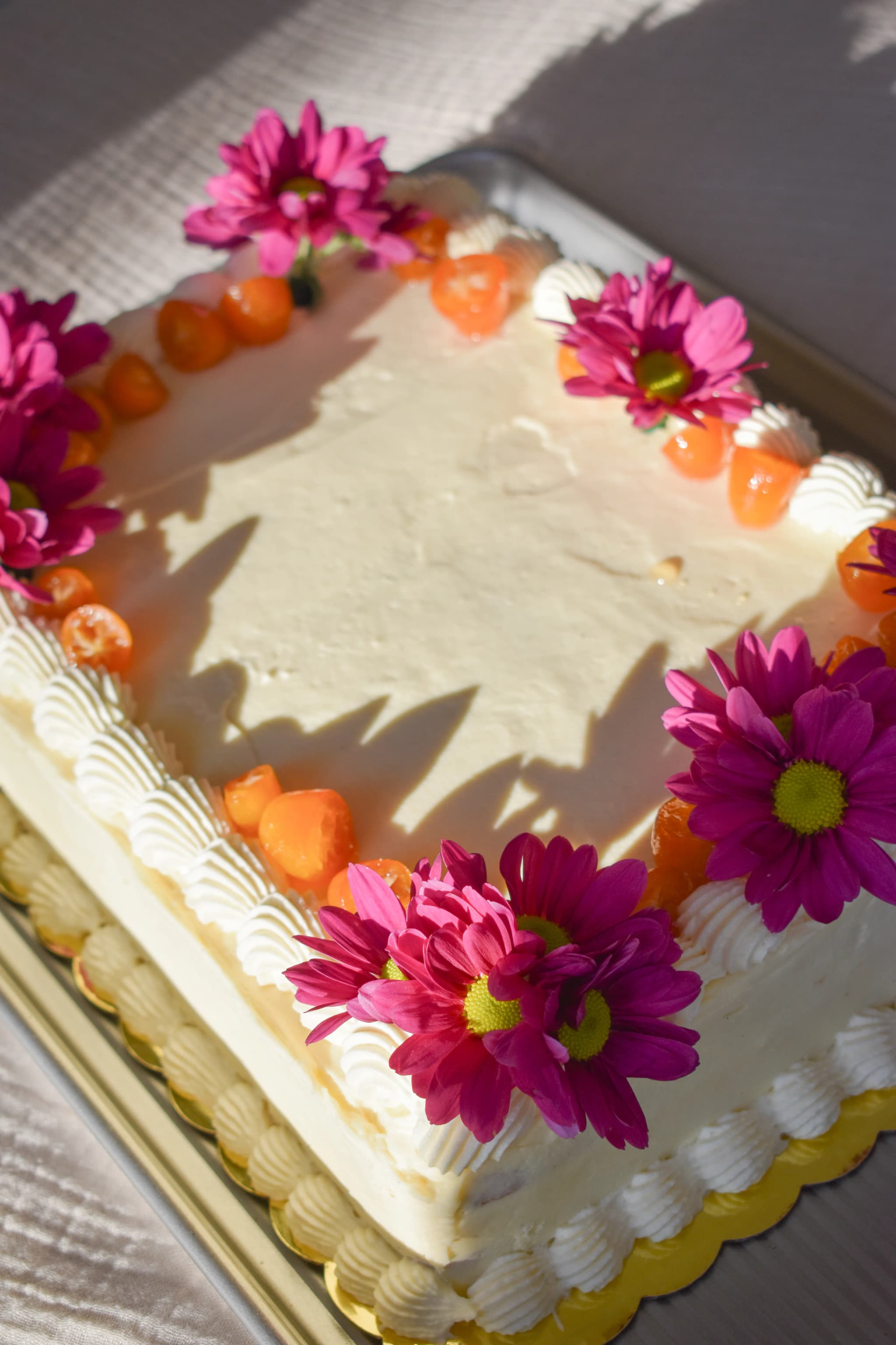 candied kumquat sheet cake with flower arrangement