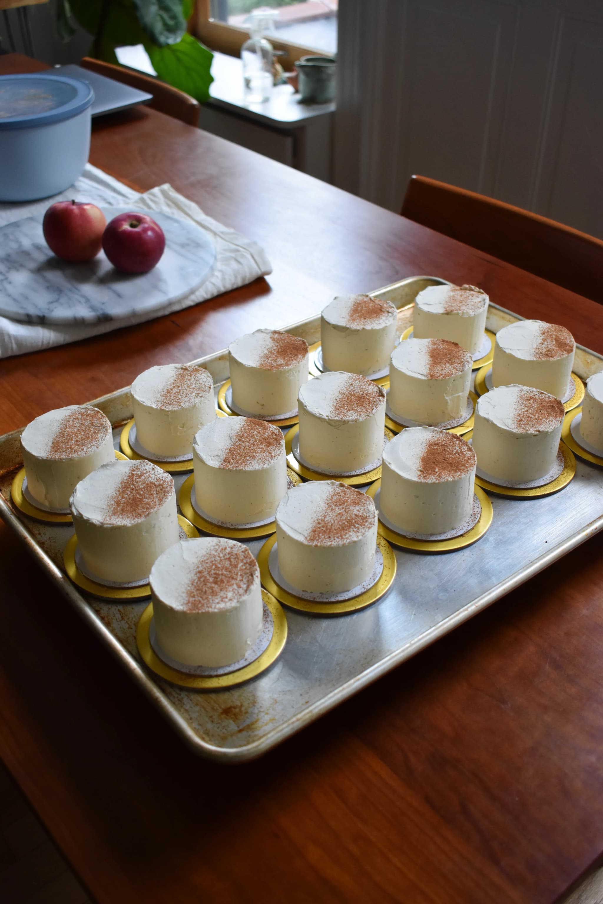 tray of mini apple cakes dusted with cinnamon